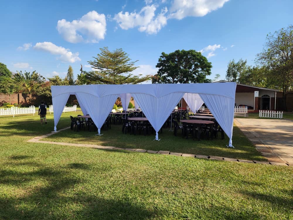 White alpine tent prepared with tables and chairs at the events centre
